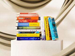 Image of the Booker Prize 2024 longlist books, stacked and arranged in a 'messy' pile